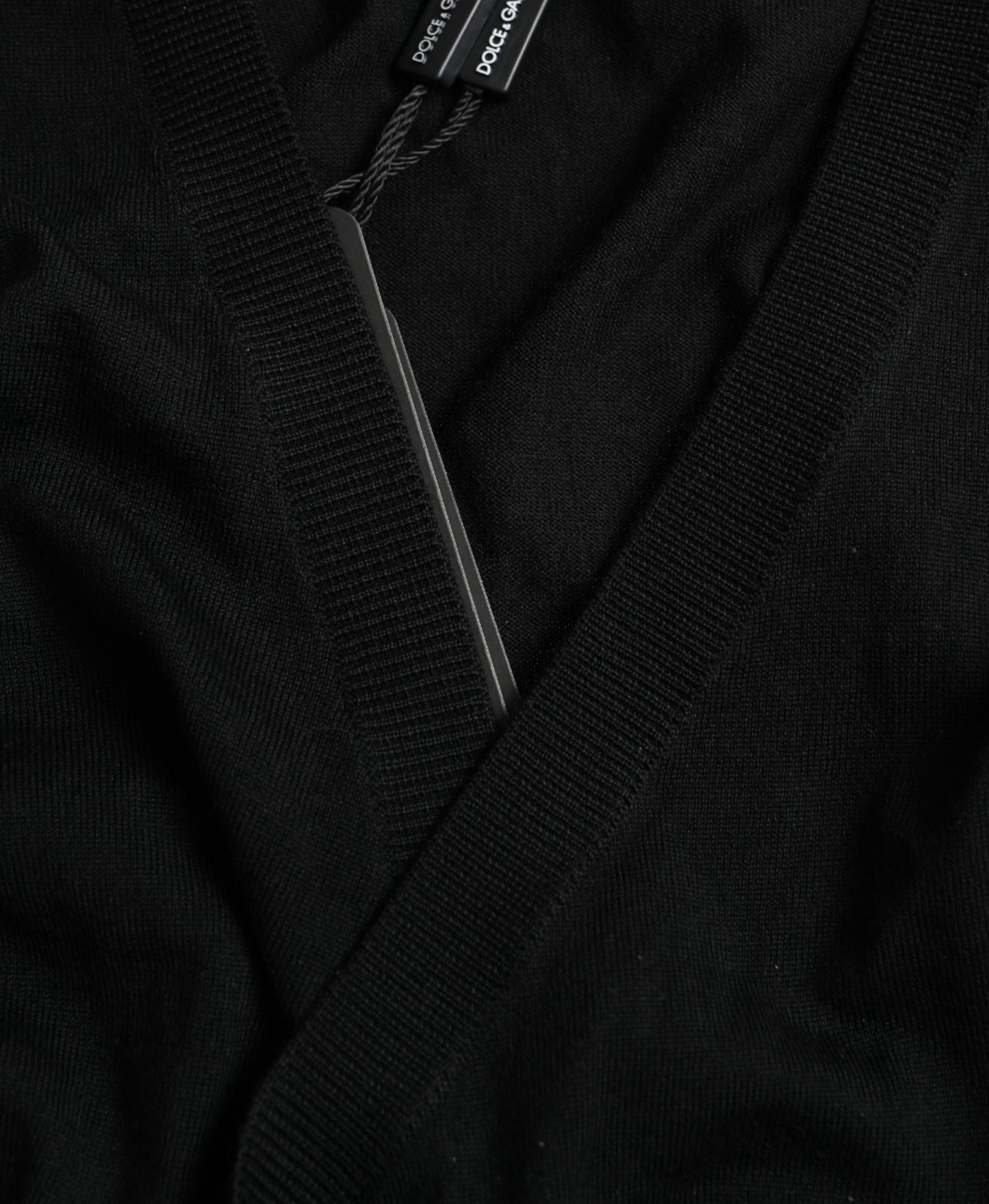 Dolce &amp; Gabbana – Schwarzer Cardigan aus Wolle mit V-Ausschnitt und gekreuztem Saum