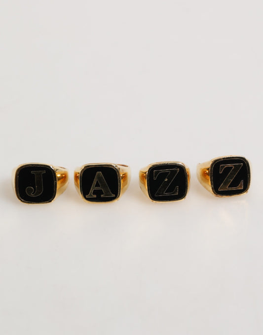 Dolce &amp; Gabbana – Goldfarbenes Messing-Buchstabenset „JAZZ“, 4-teilig, verstellbarer Ring